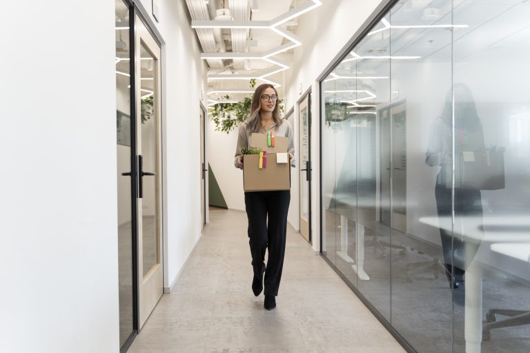 woman walking with cardboard box