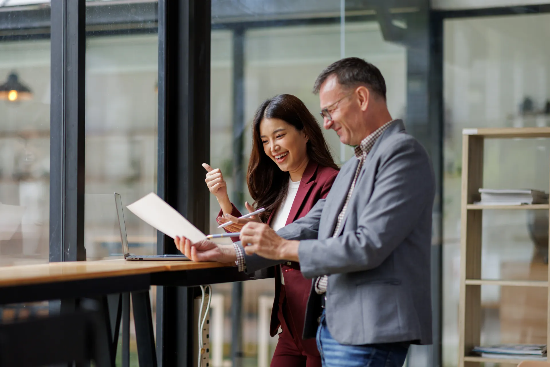 Two business working together using digital tablet pc and talking about a business project